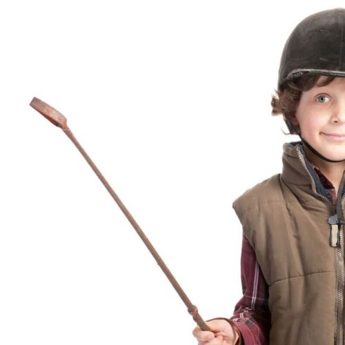 kid with equestrian helmet and crop